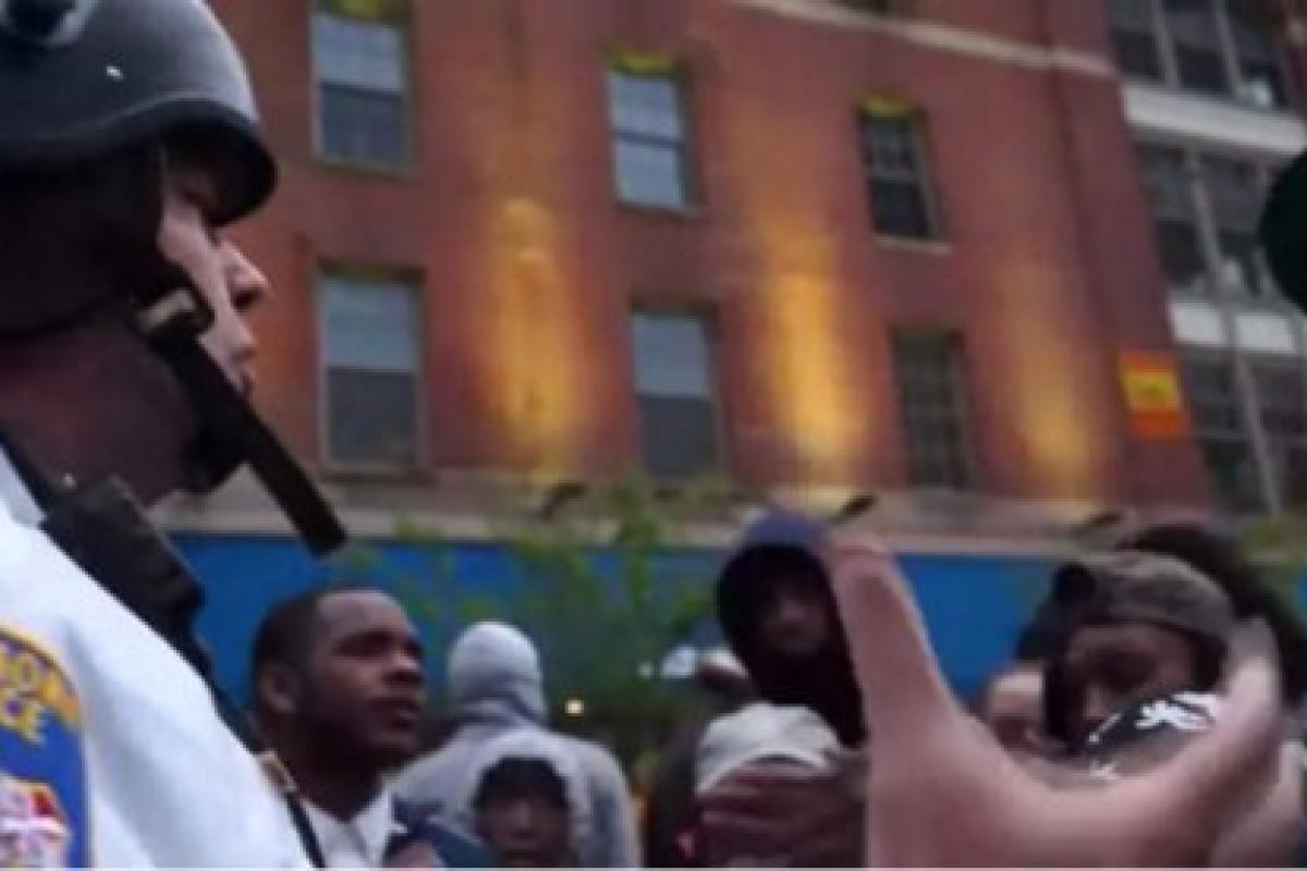police officer speaking to protesters