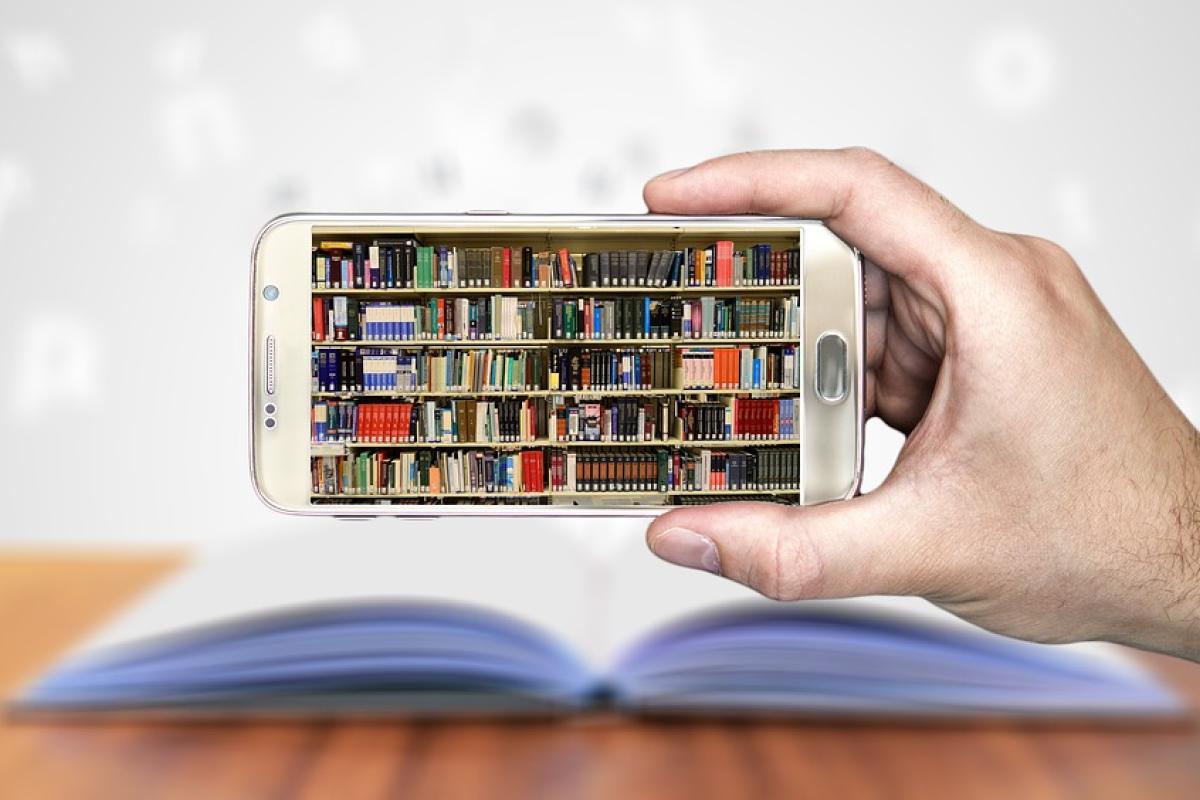 Hand holding a smartphone, whose screen displays a full bookshelf