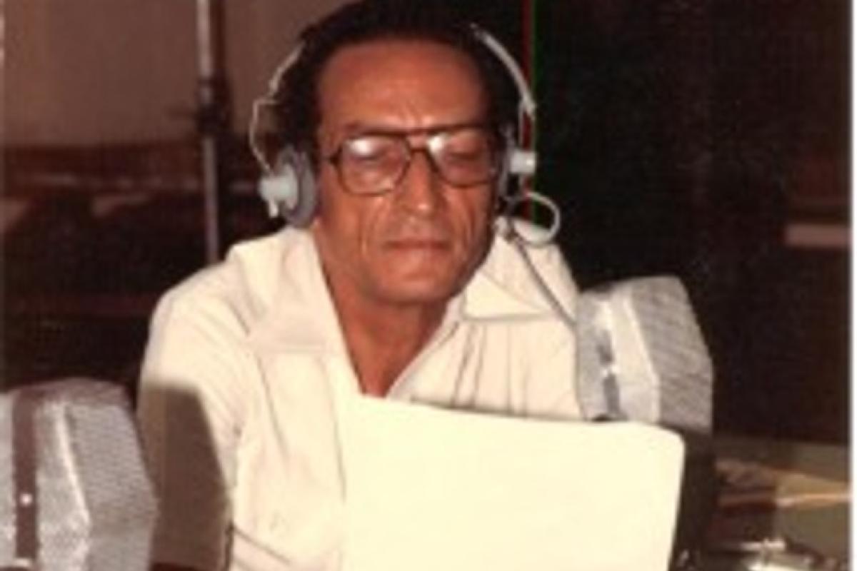 Jean Dominique at a microphone