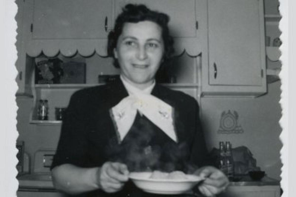 black and white photo of woman holding matzah ball soup, 1954