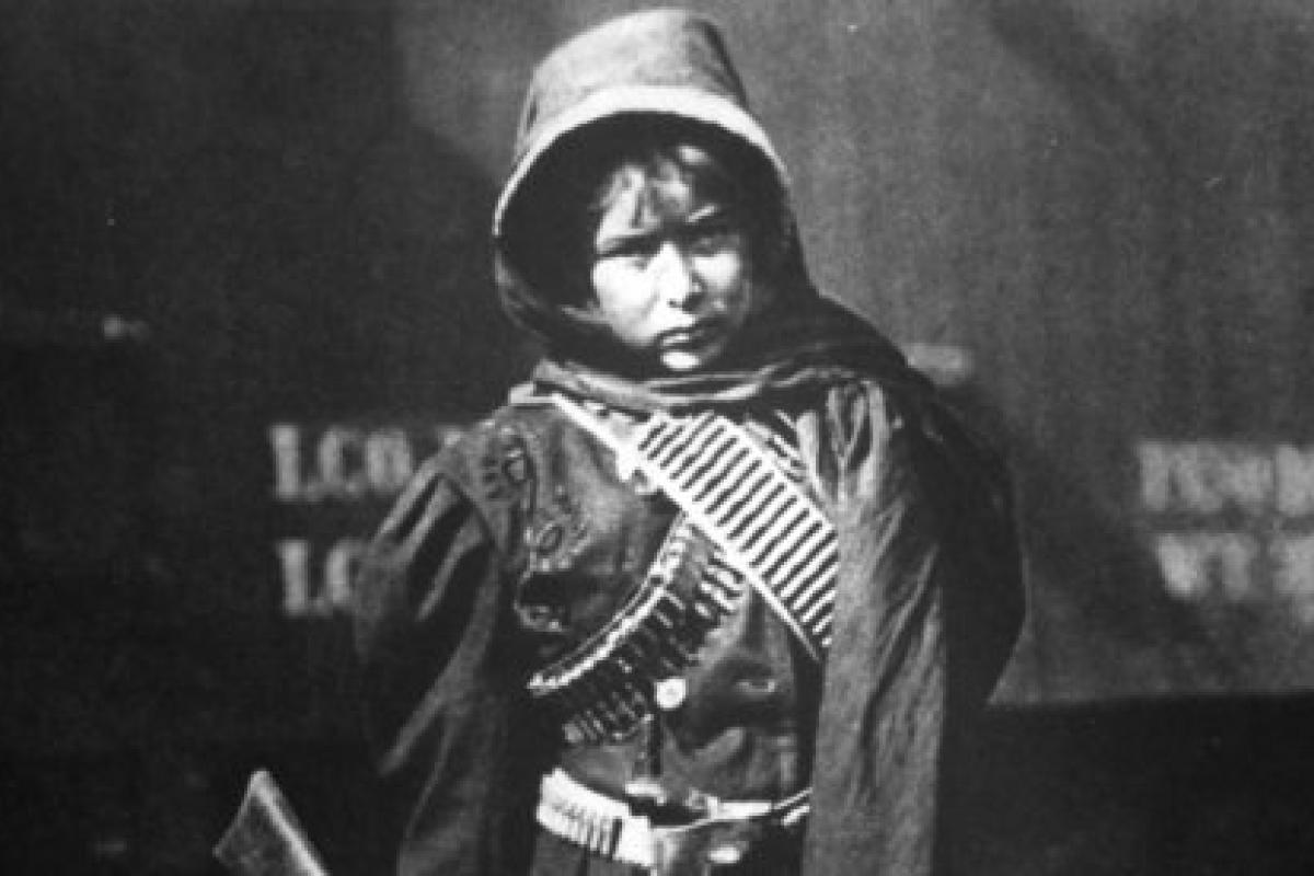 photo of boy with rifle and bandolier