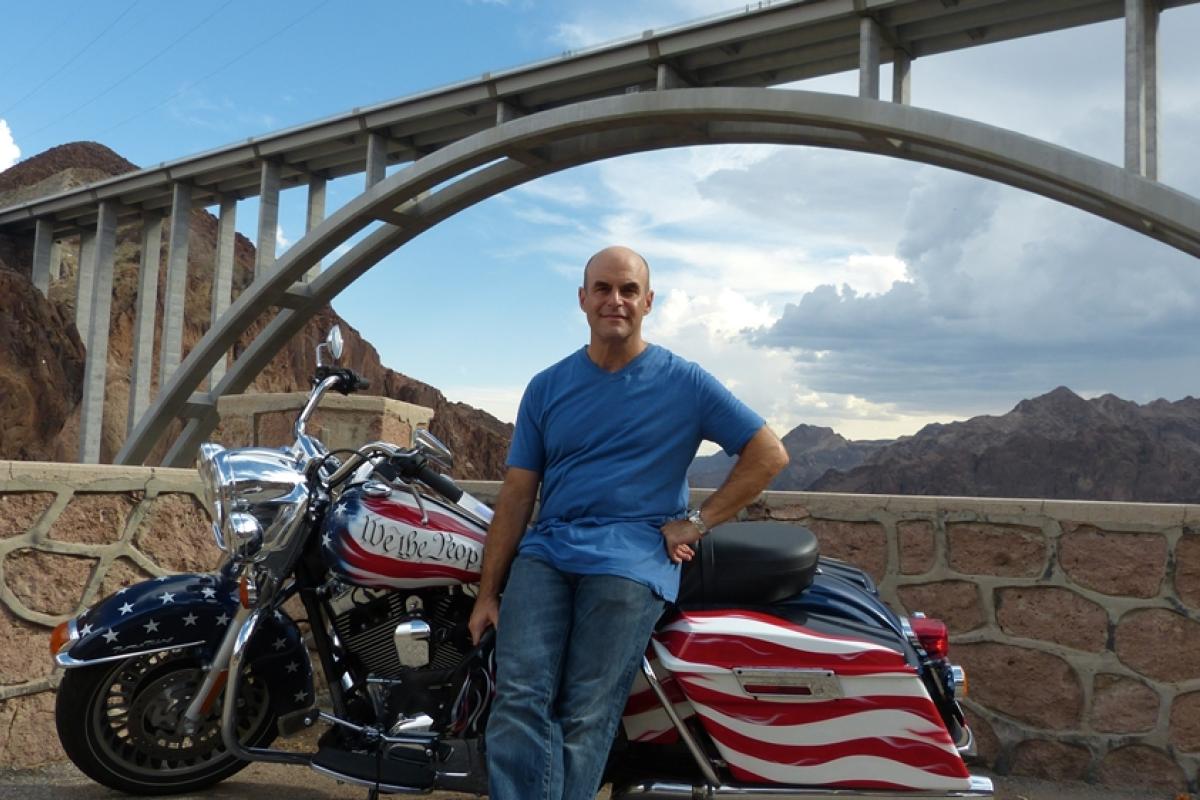 Peter Sagal, travels cross-country on a motorcycle.