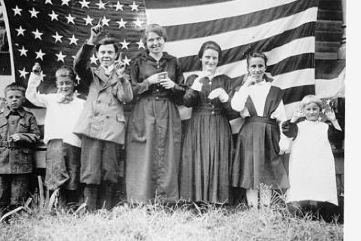 Black and white photograph of Students from the St. Rita's School for the Deaf, 1918, in front of the American flag