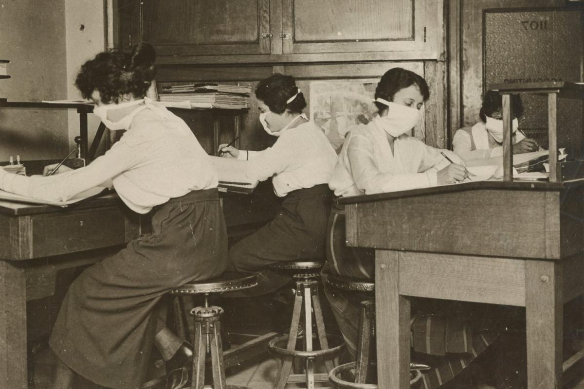 Mask for Protection Against Influenza: Girl clerks in New York at work with masks carefully tied about their faces.