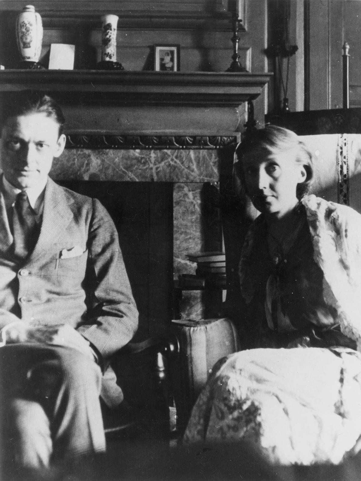 Eliot in his "four-piece suit" sitting next to Virginia Woolf