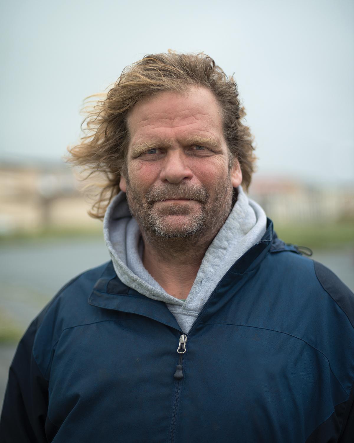 Portrait of man with hair blowing in wind