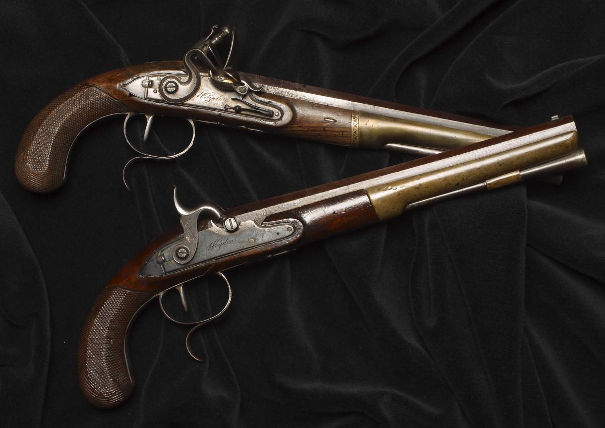 The dueling pistols used by Hamilton and Burr, on top of a black background