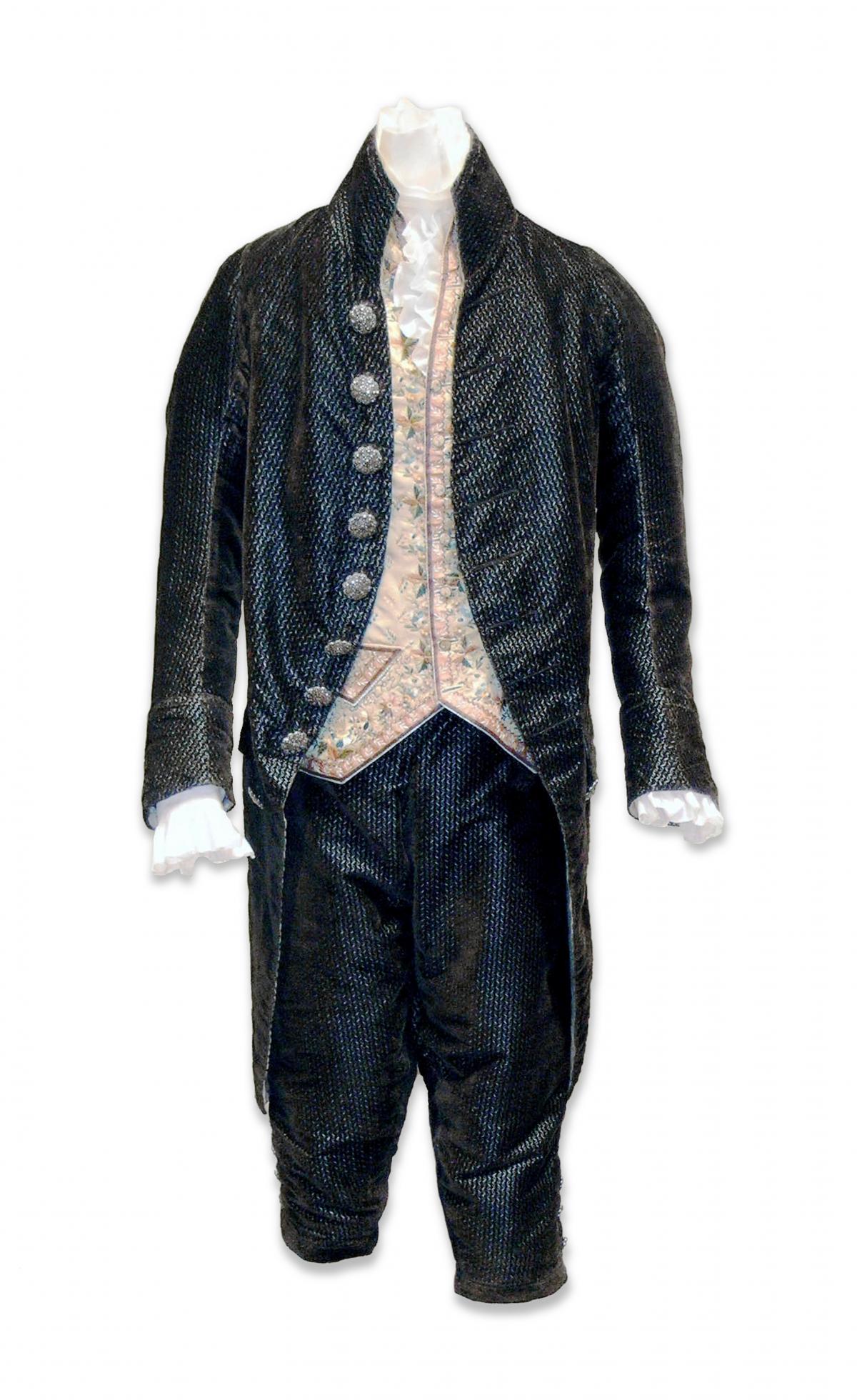 Dark blue velvet suit and trousers, with a pale pink floral embroidered waistcoat underneath, on a mannequin