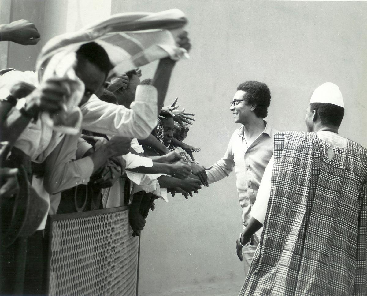 Collinet reaches out his hand to a crowd of eager fans, held back by a small wire barricade