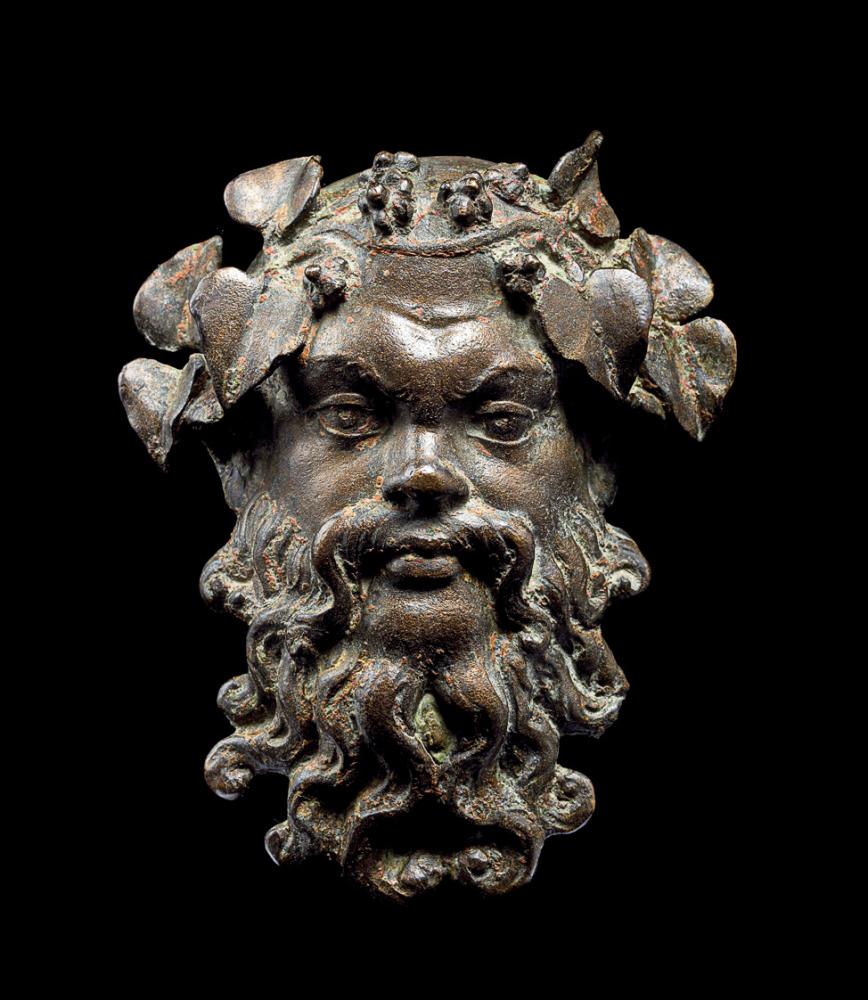 Photograph of a bronze mask of a man with a beard