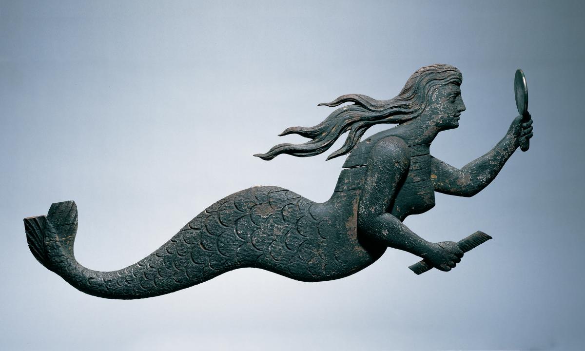 carved mermaid figure in profile