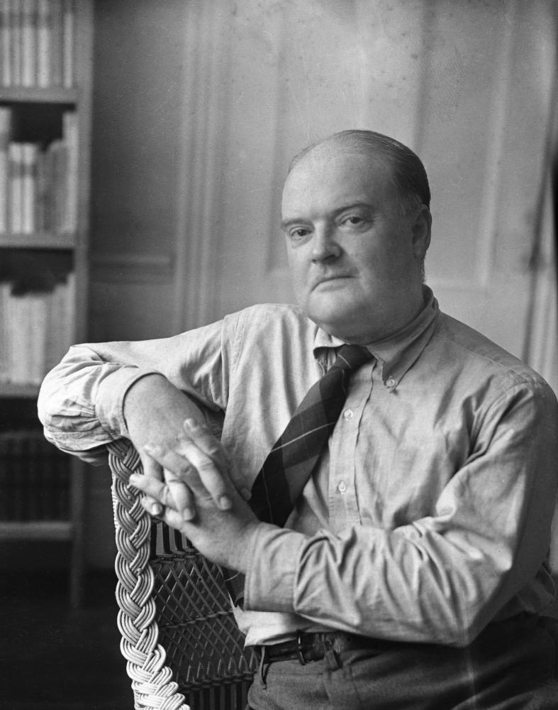 Black and white photograph of man sitting in chair