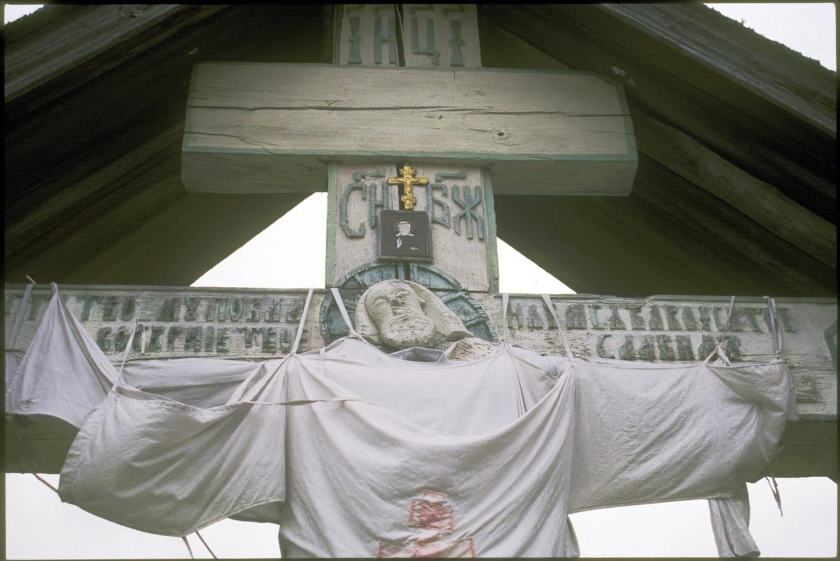 photograph looking up at a crucifix memorial