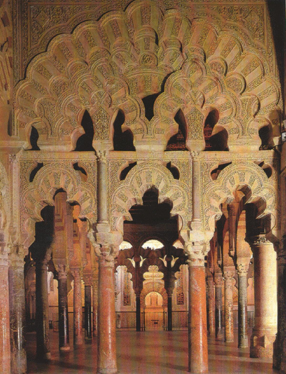 Scalloped arches in gold, with red marble columns