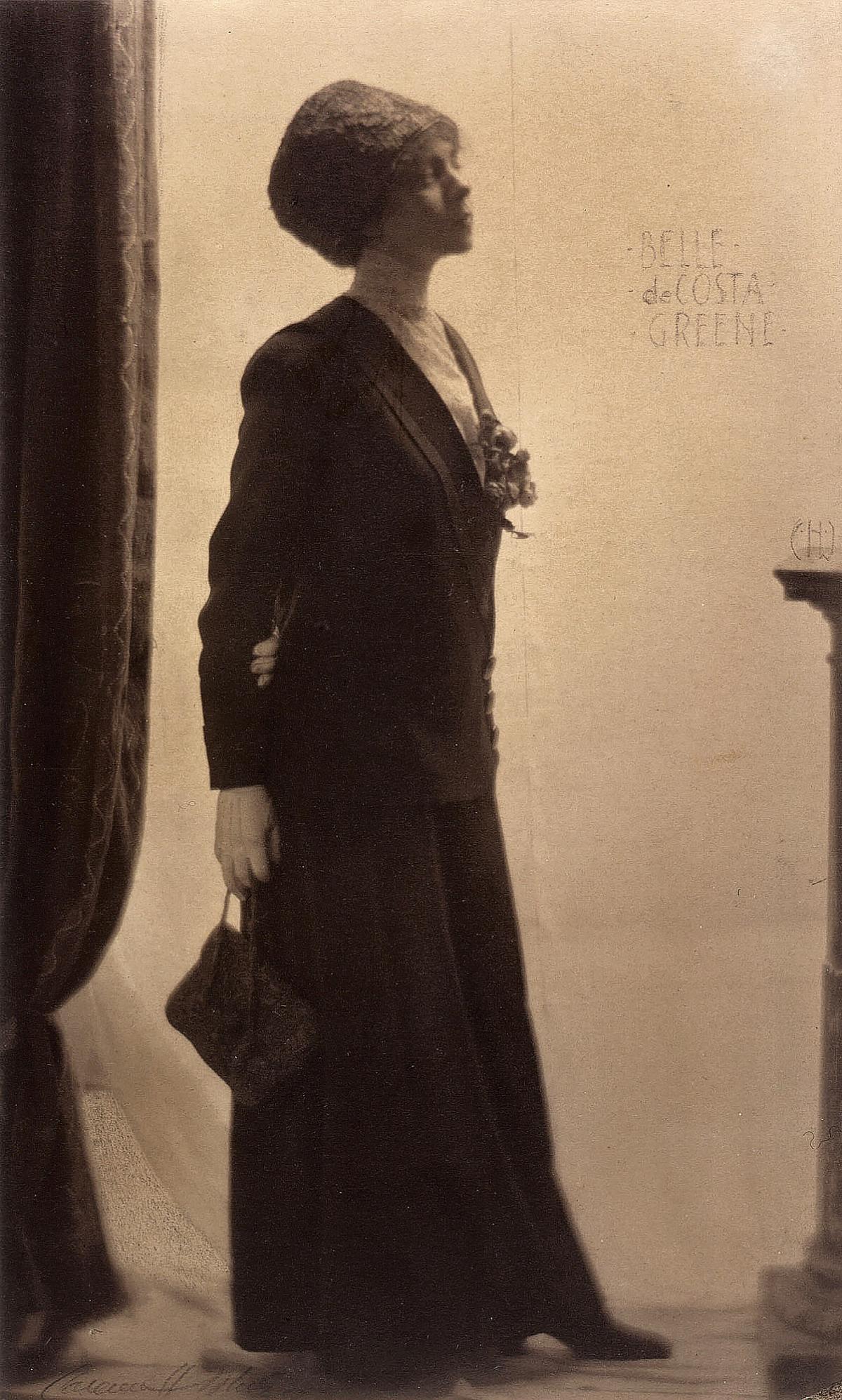 Greene, in a long black dress and cap, chin raised