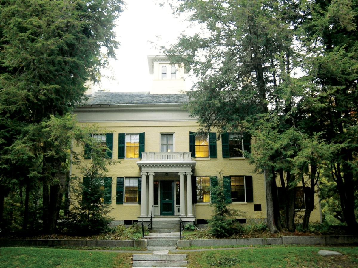 photograph of facade of a yellow brick house