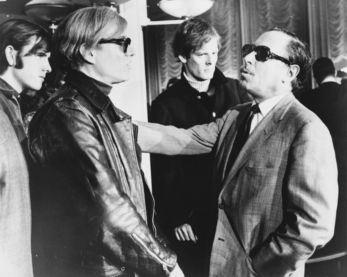 black and white photo of two men talking
