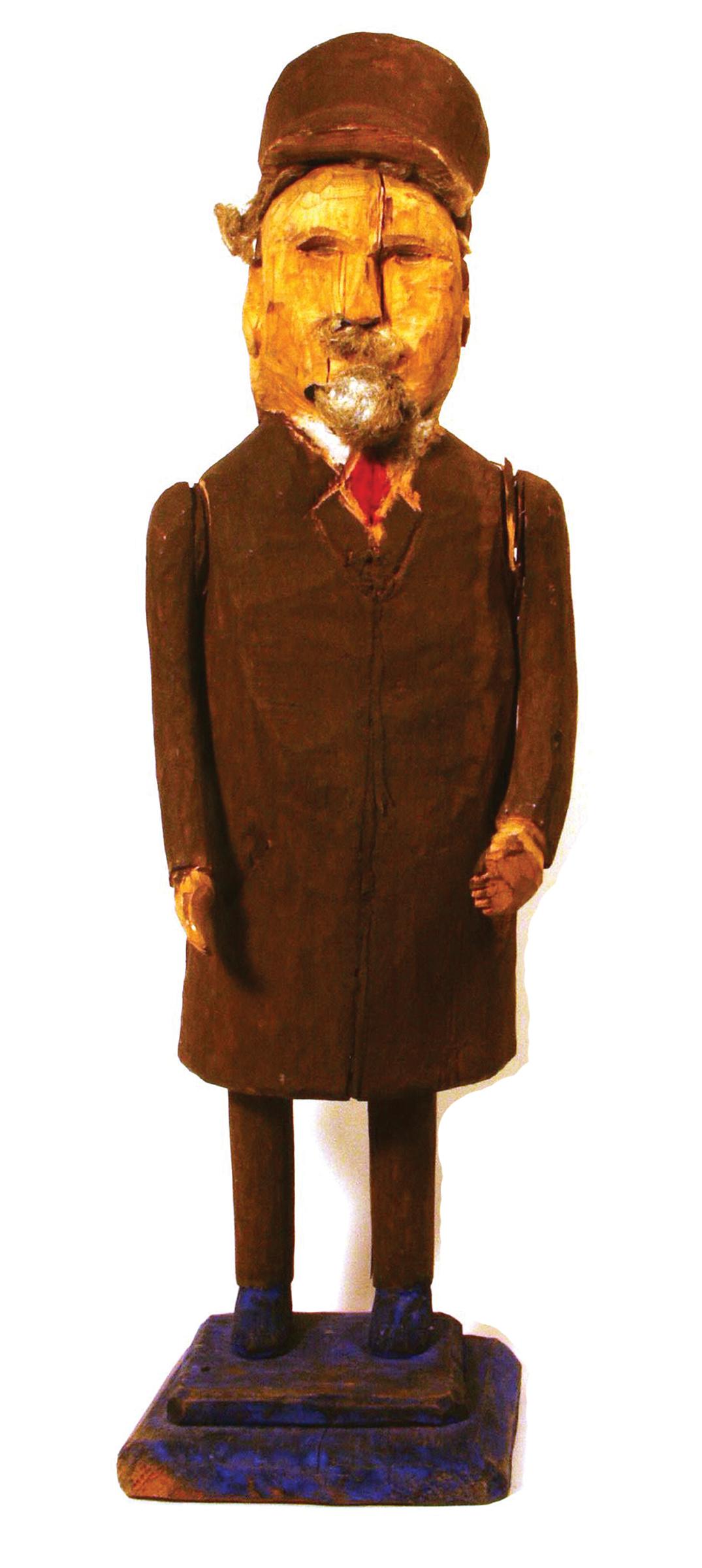 Wooden statuette of Lenin, wearing a cap and brown overcoat