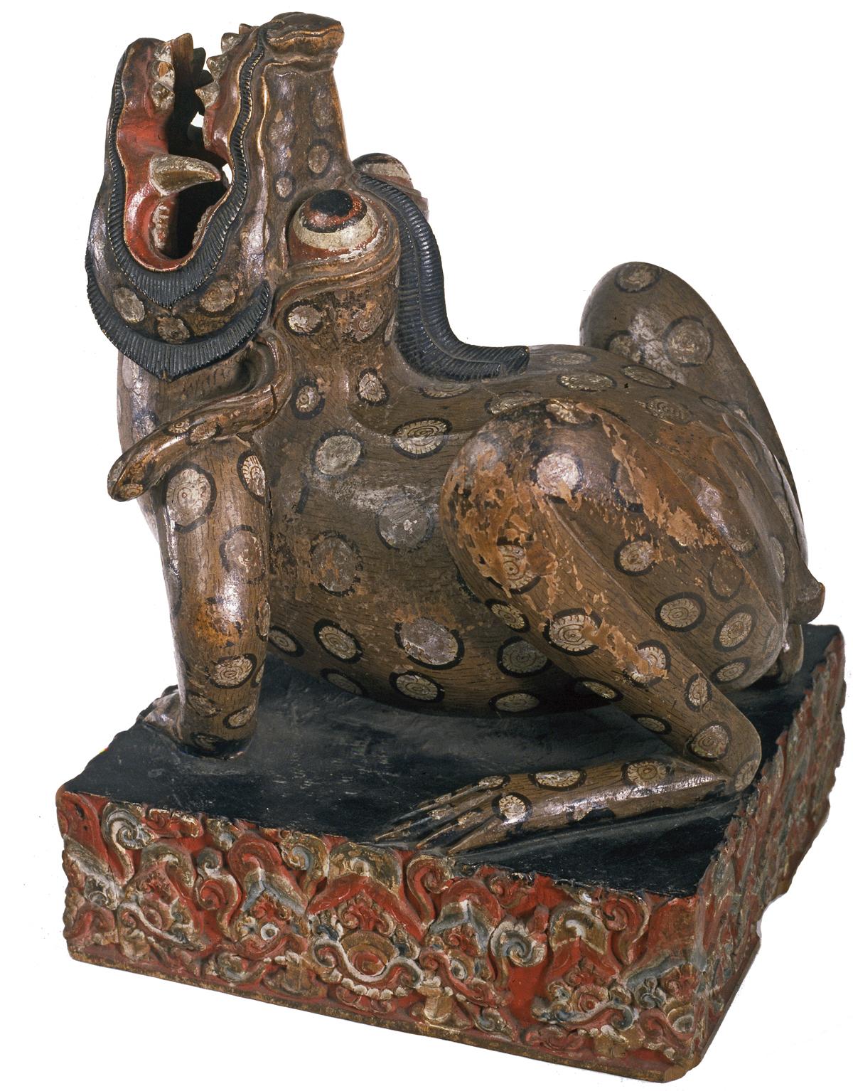 Bronze colored dagger stand, with the open mouth of the beast intended to hold the dagger