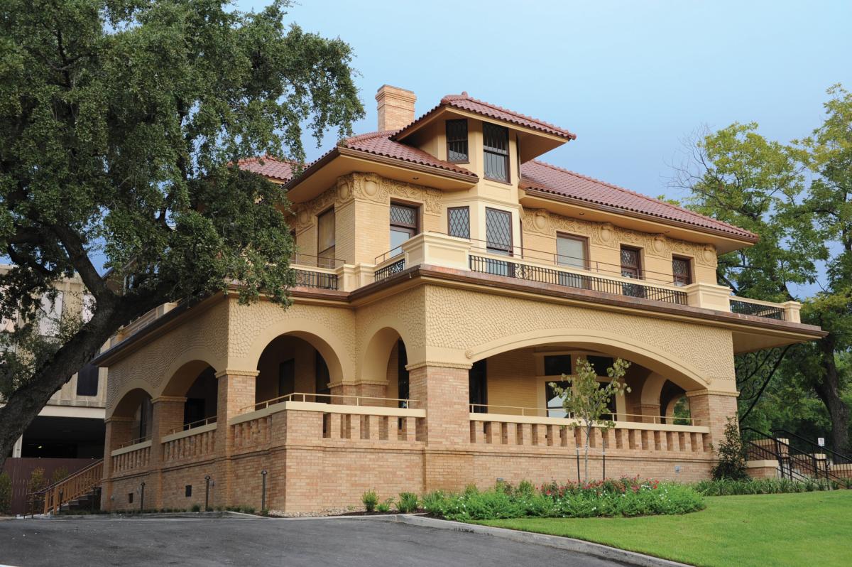 Byrne-Reed house restored, in cream-colored brick with tan tiled roof and graceful arches over the porch