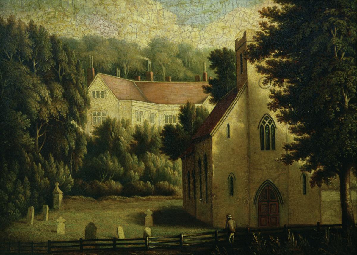 A red-roofed house and church, surrounded by green fields and trees