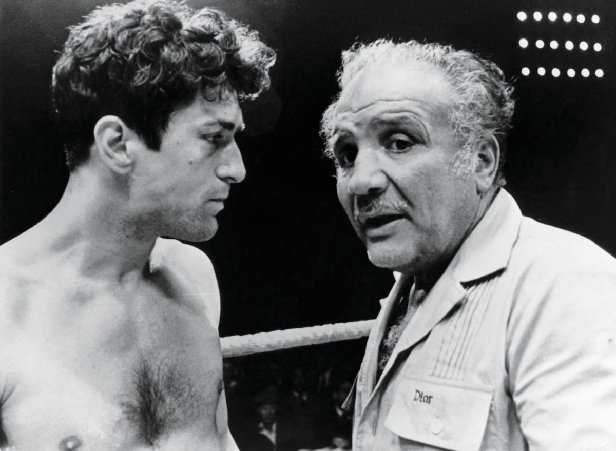 de Niro, shirtless, talks to LaMotta in the boxing ring