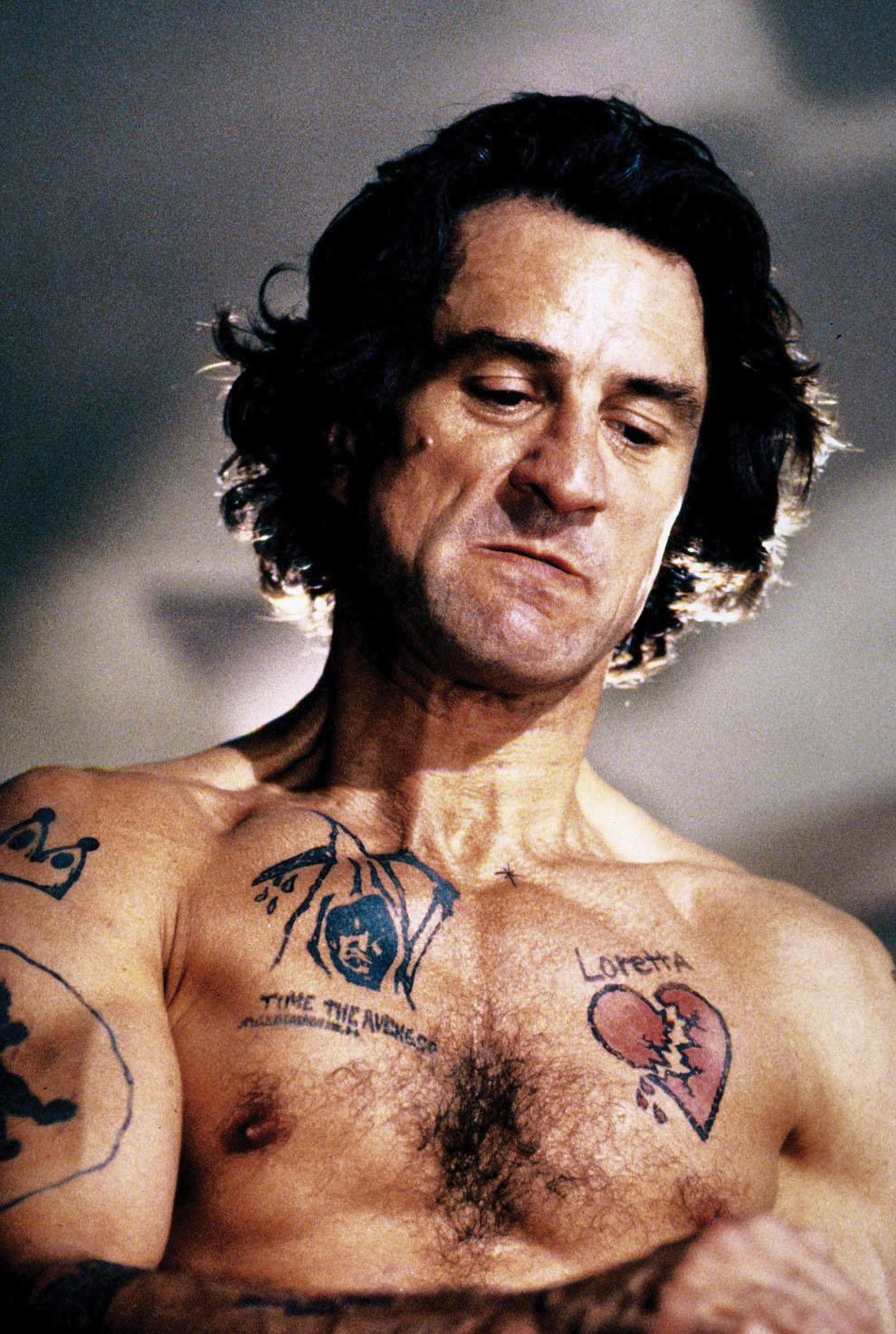De Niro, shirtless and covered in tattoos