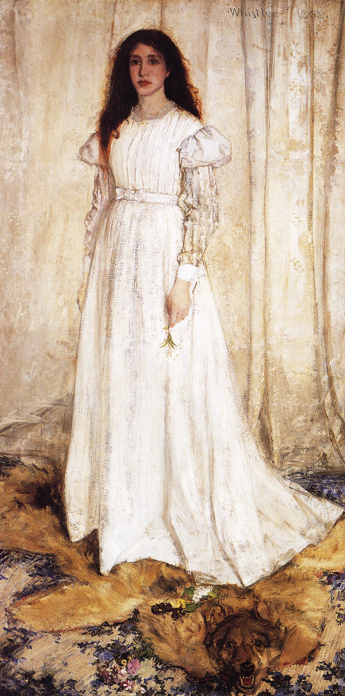 Woman with loose, dark, curly hair in a long white dress