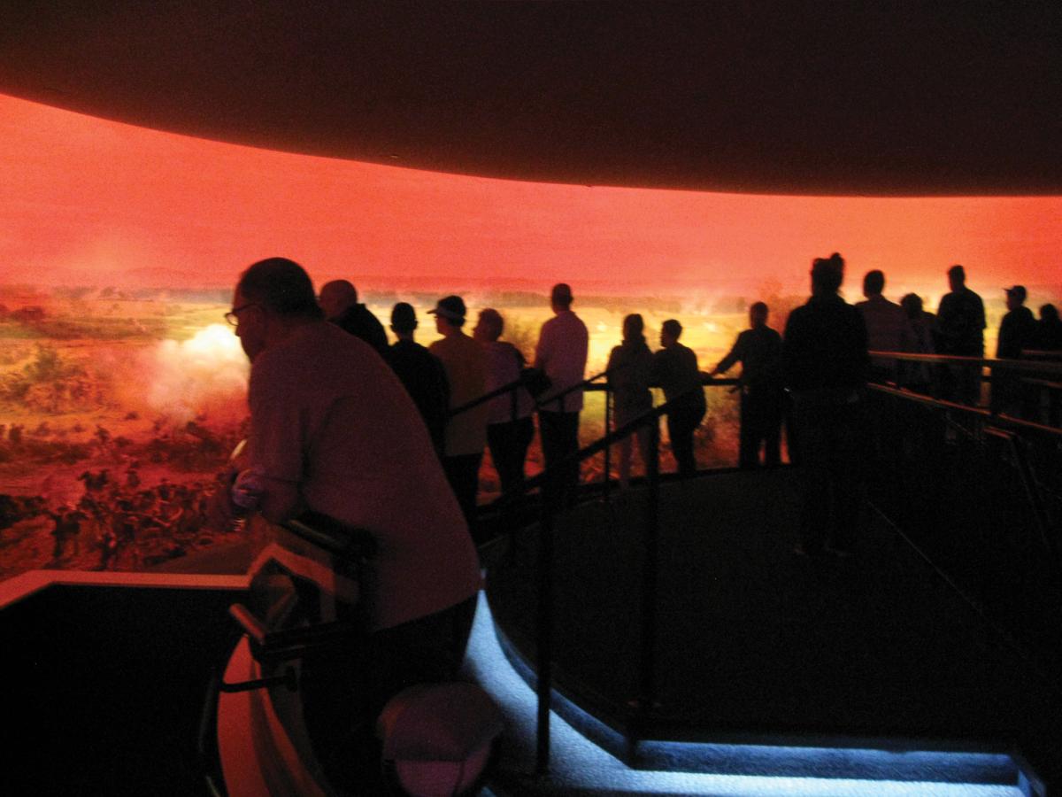 photograph of crowd of people viewing panoramic art