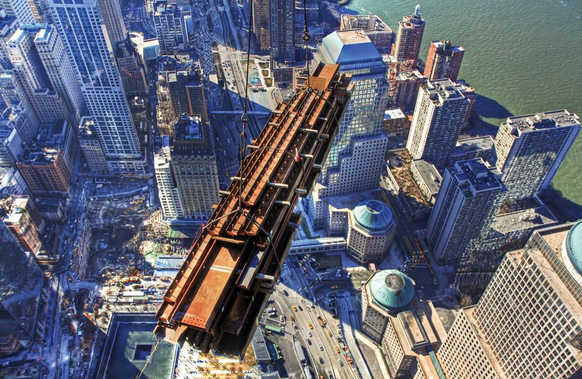 Aerial photograph of a crane lifting a shipping container