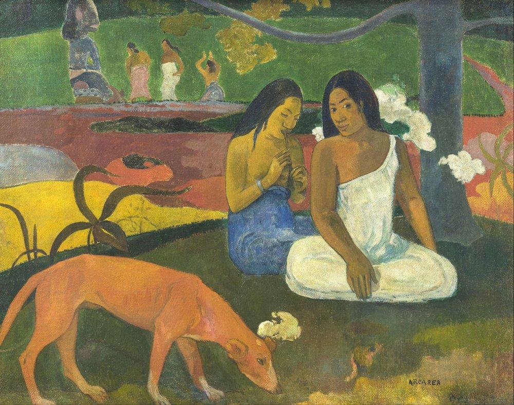 Two women seated under a tree, with a dog in the foreground.