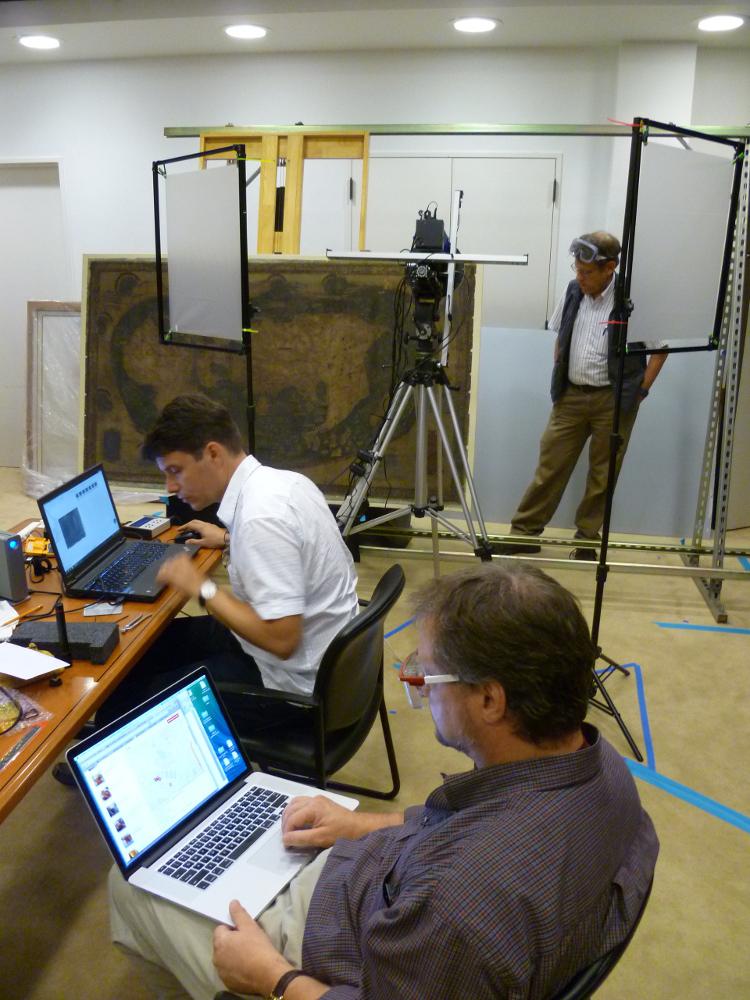 Roger Easton checks the positioning of the map for the next shot; Gregory Heyworth operates the computer that controls the camera; and Michael Phelps monitors the process.