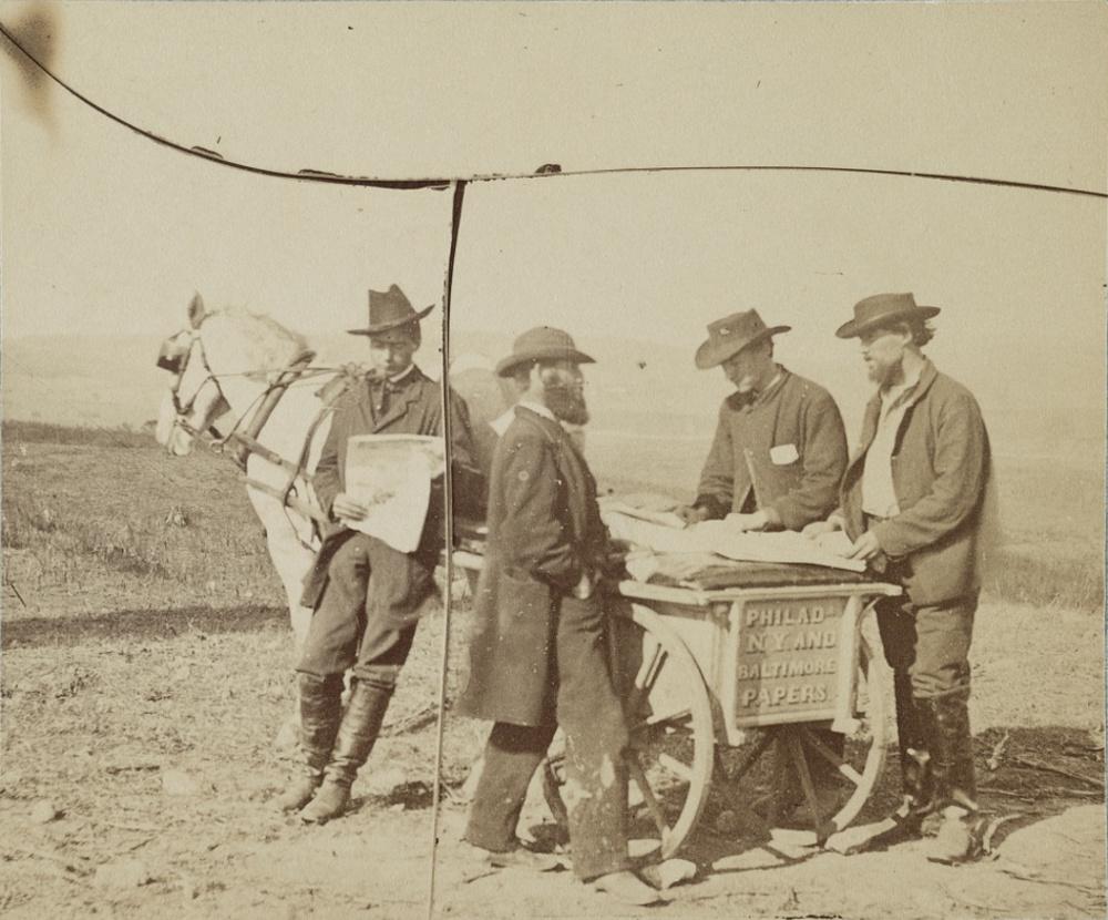 Newsboy in camp, 1863. By Alexander Gardner.