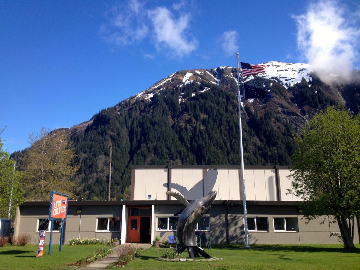 Image of the Juneau Arts & Culture Center with Mount Juneau pictured in the distance