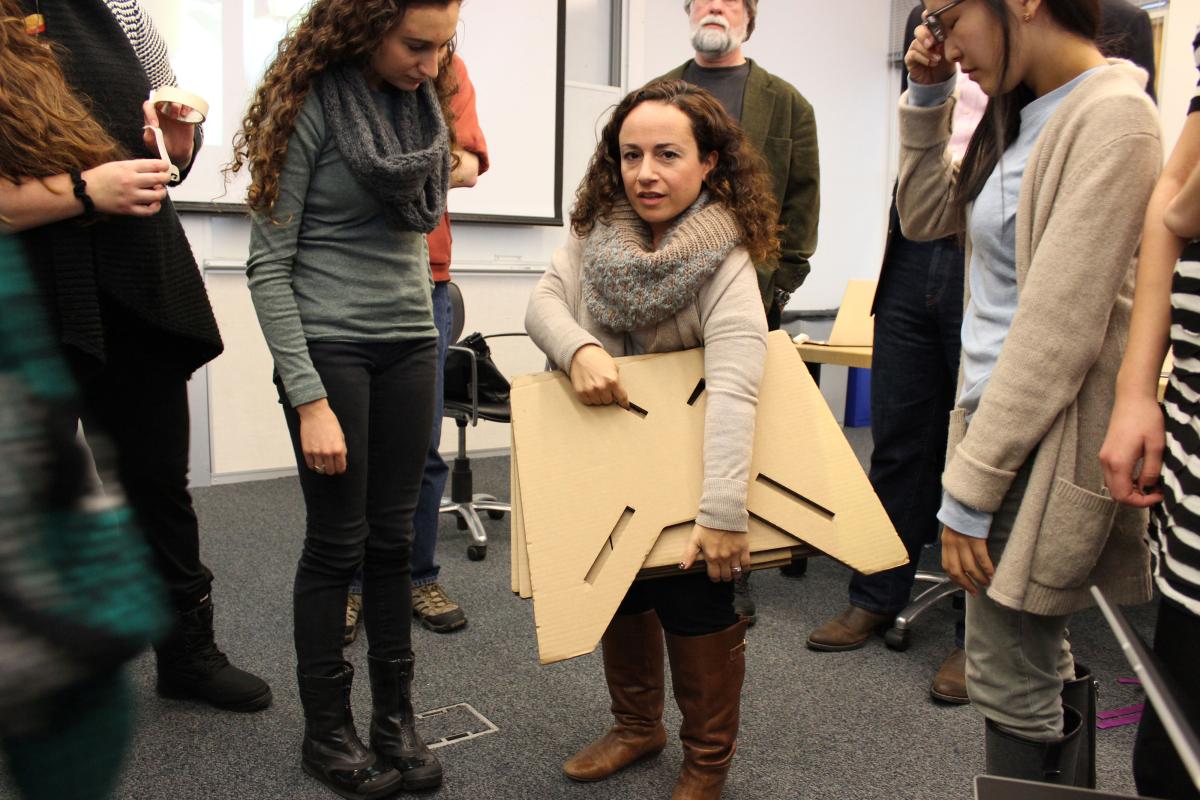 Art historian Amanda Cachia holding a portable lectern. 