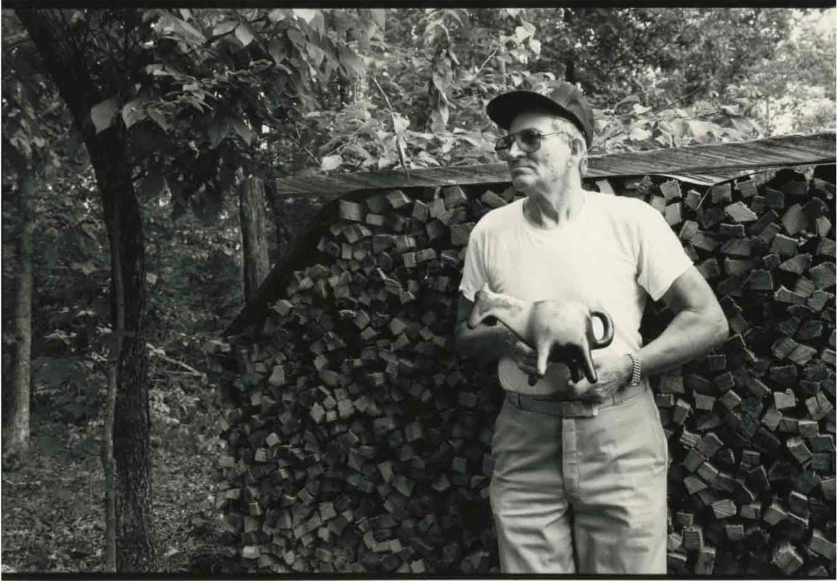 photograph of the potter Earl Lewis holding one of his pieces