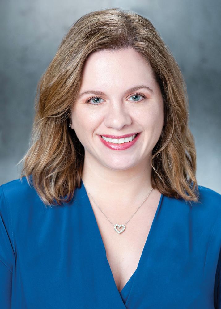 Photograph of Amy Stanley, wearing a blue blouse.