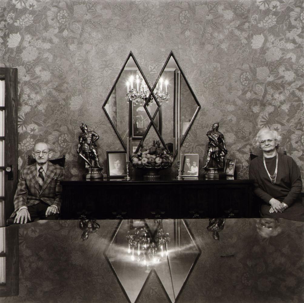 black and white photo of couple in dining room