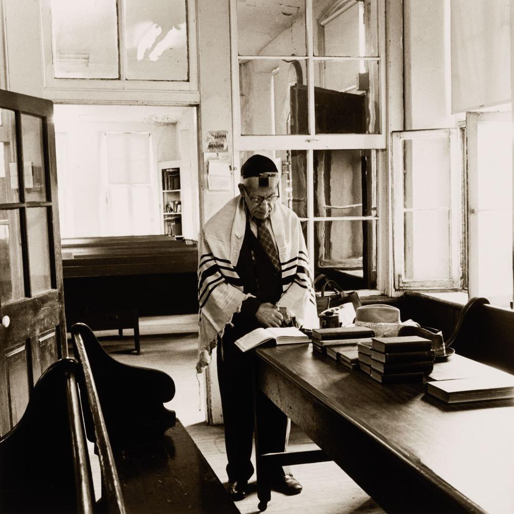 black and white photo of Jewish man reading prayers