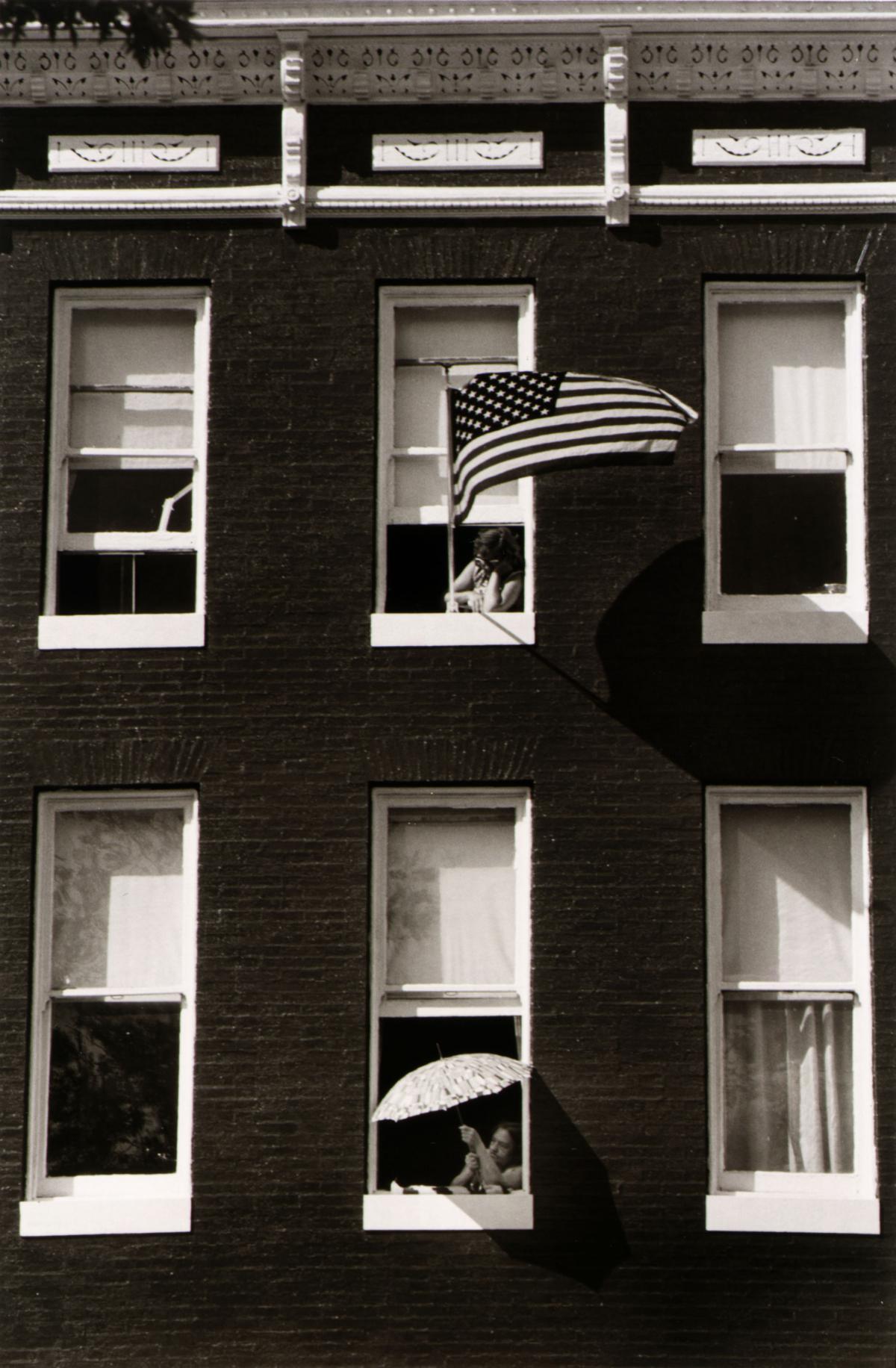 black and white photo of a row house with an American flag