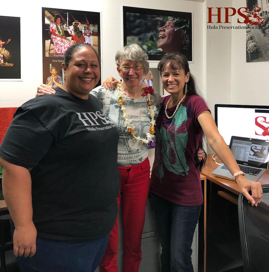 Collections Manager Keau George (left) and HPS Executive Director Maile Loo (right) welcome Jeanne Drewes (center) into the Hula Preservation Society in Kāneʻohe, Oʻahu. 