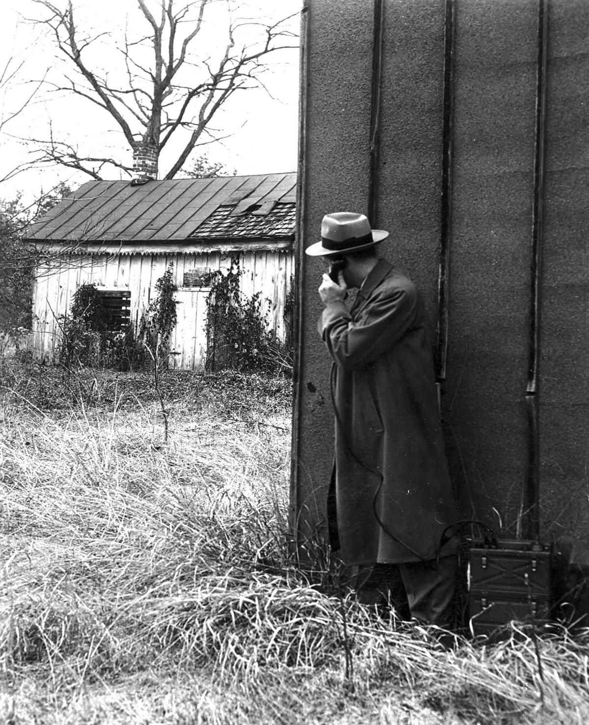 black and white photograph of FBI circa 1930 listening to a phone line