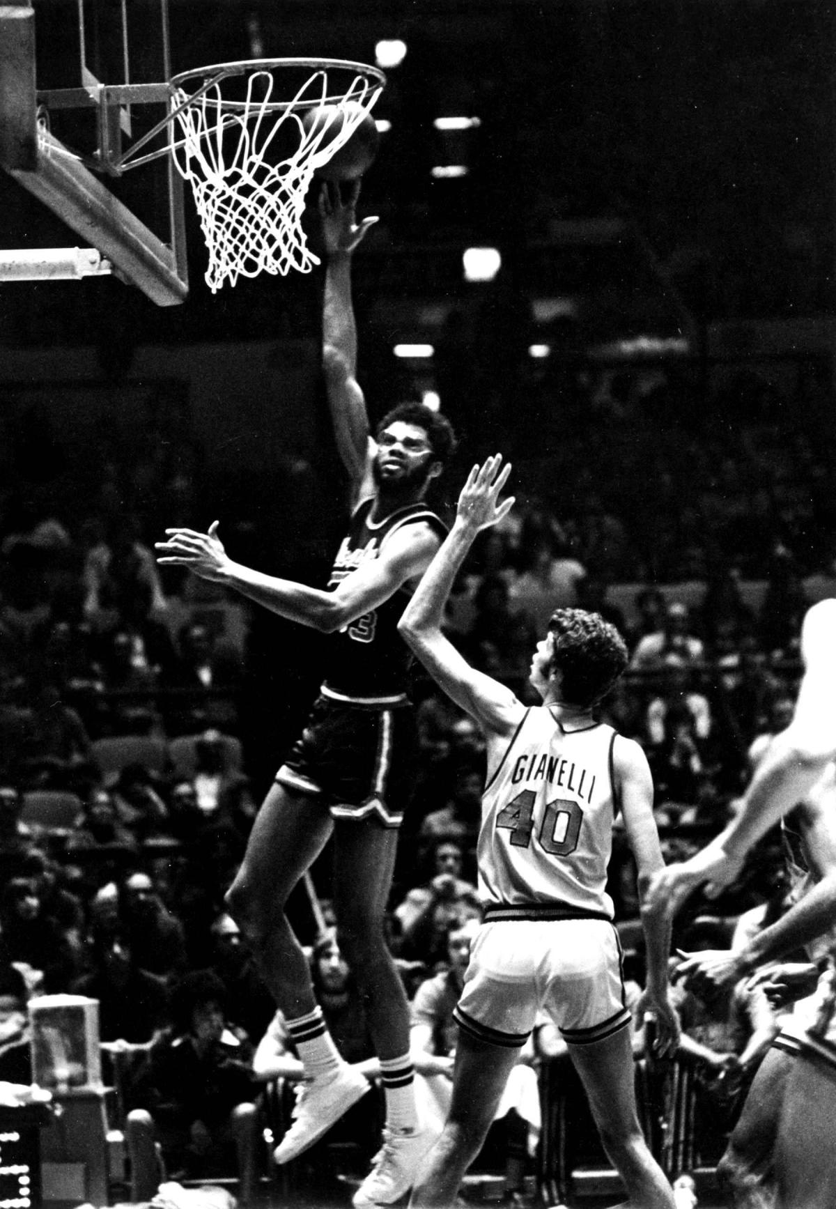 Kareem Abdul-Jabbar dunking a basketball