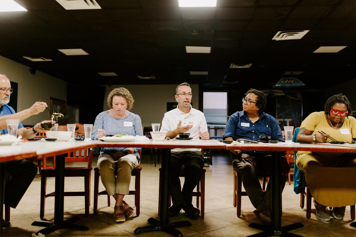 Director of Engagement Marisol Gouveia (second from right) listens as an attendee joins the conversation during a session of the Chew on This program, which utilizes food and drink as a convener of people and as a catalyst for conversation to inspire thoughtful discussions on engaging topics.