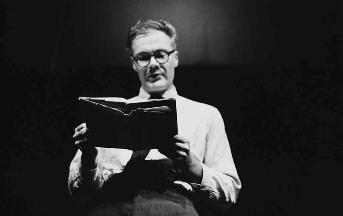 black and white of Robert Lowell reading poetry