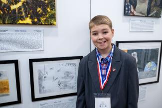 student Arliss at American Heroes Student Art Contest exhibition