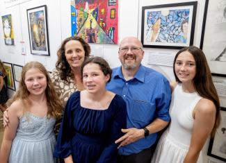 family at student art exhibition