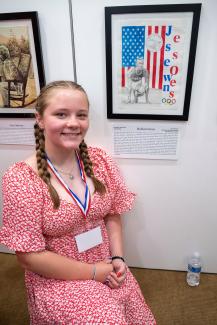 student Madison with Jesse Owens artwork