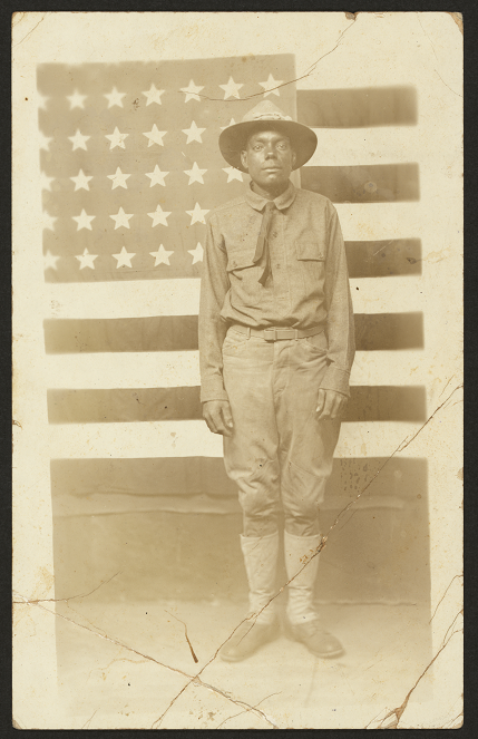 African-American soldier in front of an American flag, WWI