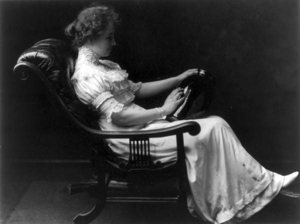 Black and white photo of Helen Keller sitting in chair